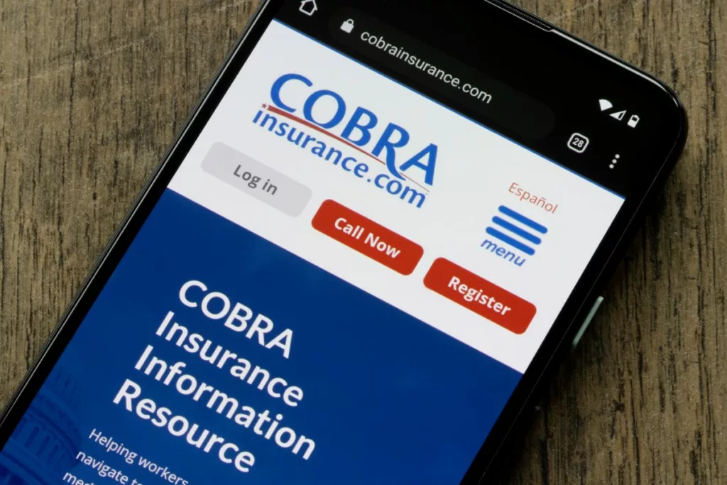 A smartphone showing COBRA' s homepage.